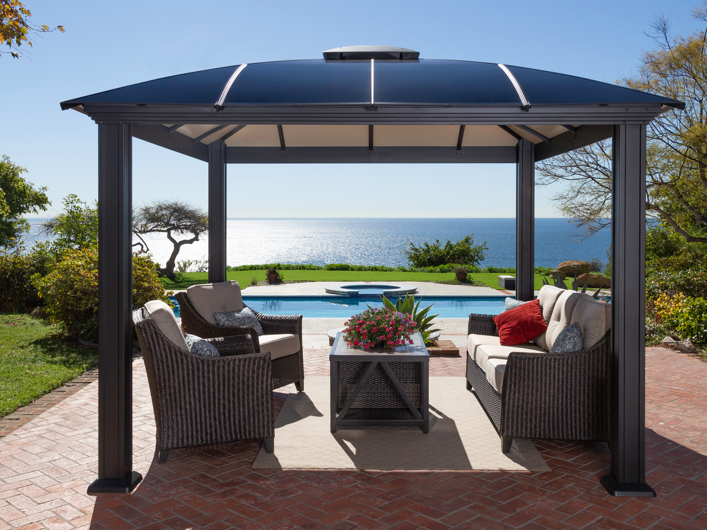 Cambridge Hard Top Gazebo on brick patio with outdoor furniture underneath.